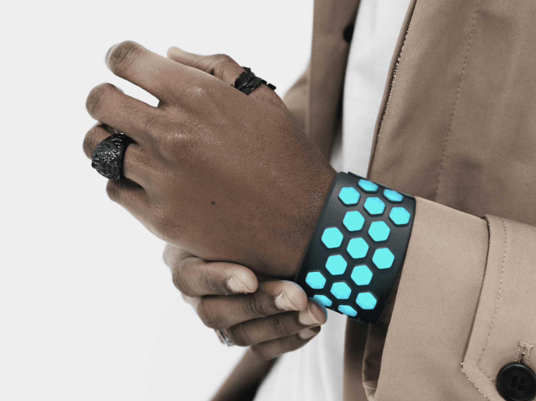 A glowing haptic cuff prototype worn on a wrist